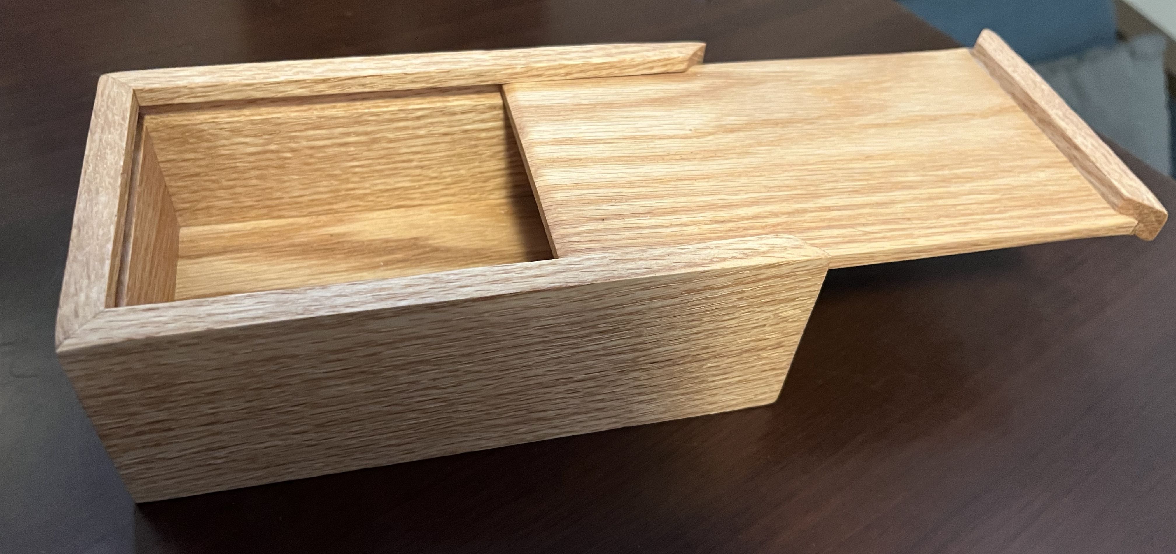 Wooden keepsake box with a partially opened sliding top